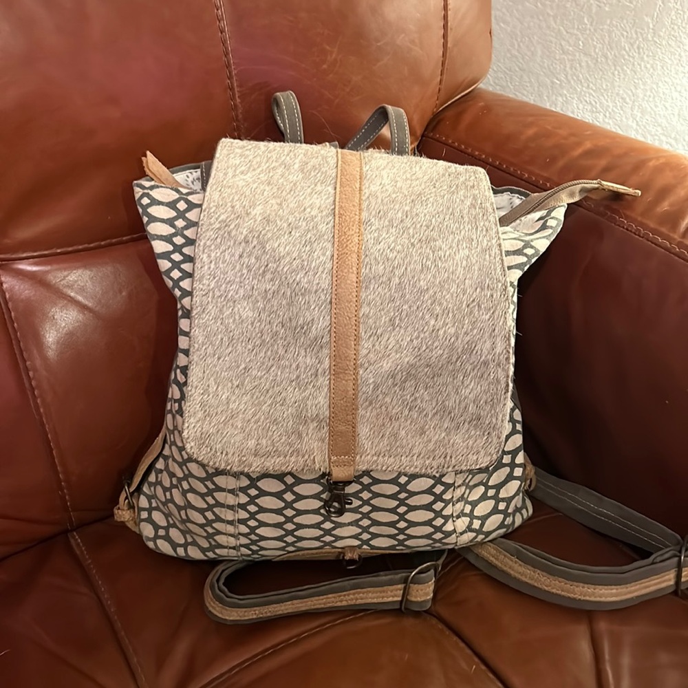 Myra honeycomb pattern backpack with hide front. Very clean. Leather straps.
